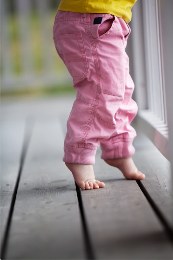 young child walking on tiptoes