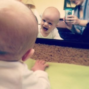 Baby looking in mirror while on tummy
